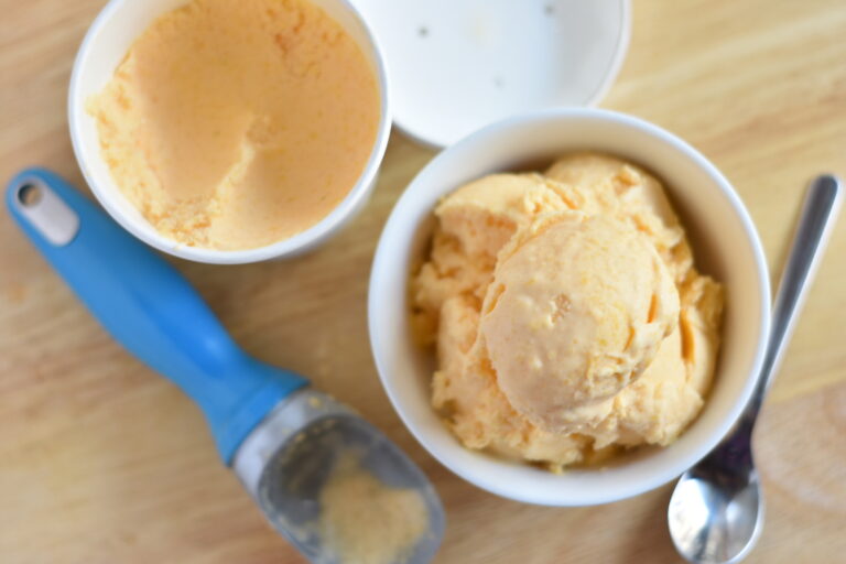 Creamy homemade mango ice cream in a dish