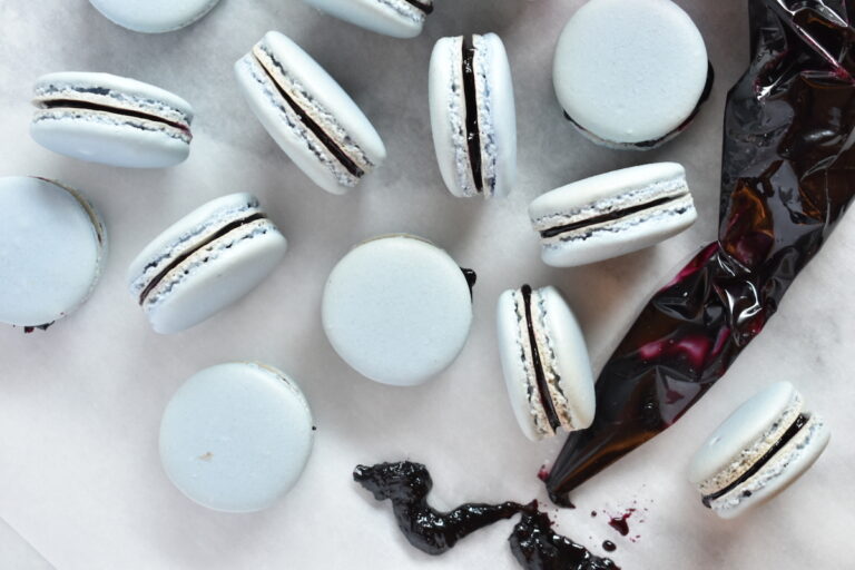 Blueberry macarons and a piping bag of jam