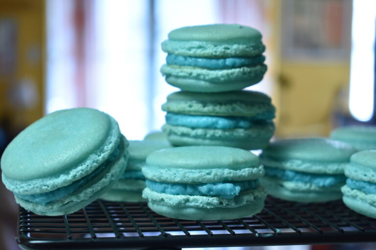 Blue macarons on a wire rack