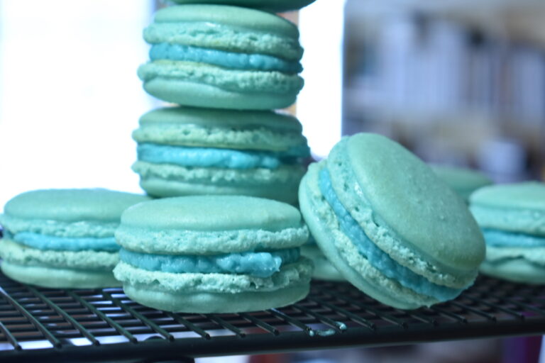 Blue macarons on a wire rack