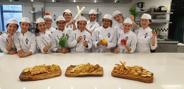 Student chefs at Le Cordon Bleu celebrating the last practical class of the term 