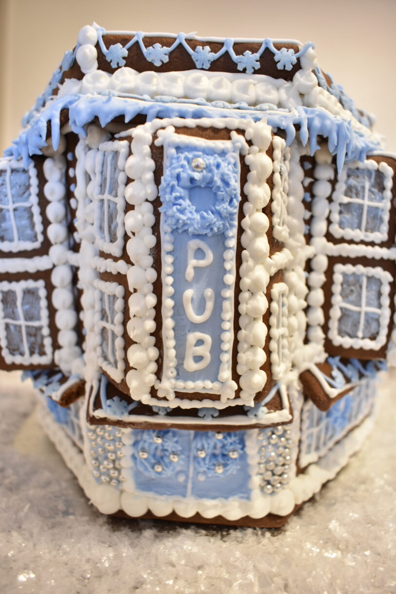 Gingerbread pub with blue and white royal icing piping