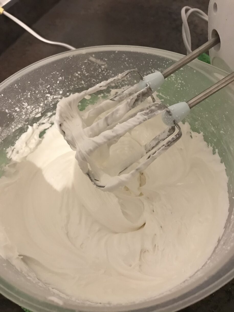 A mixer and a bowl of royal icing to make a gingerbread pub