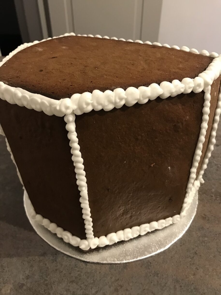 Piping royal icing on gingerbread house
