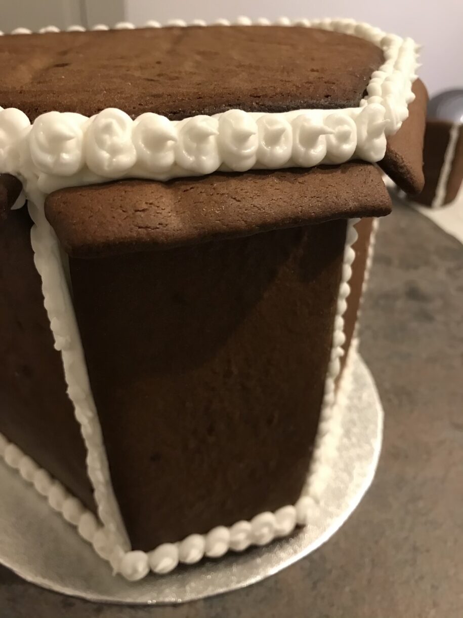 Gingerbread house construction with royal icing piping