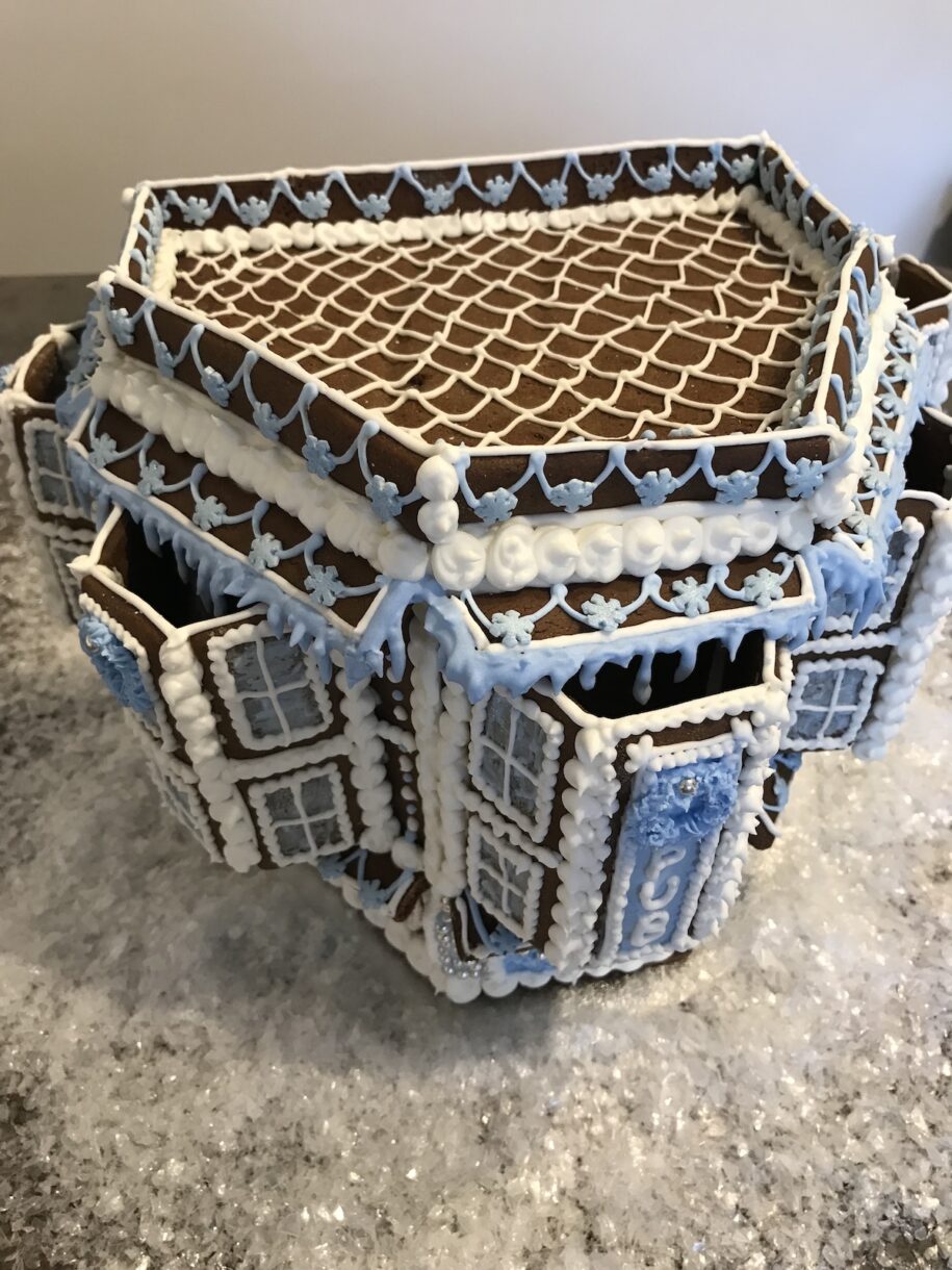 Gingerbread pub with blue and white royal icing piping