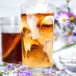 Lavender iced coffee food photograph, with purple flowers surrounding