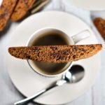 Biscotti cookie balanced on a cup of coffee