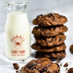 Photograph of a stack of cookies and jug of milk