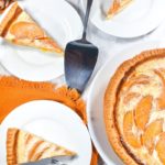 Peach custard pie and slices on plates