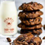 Original food photography of a stack of chocolate cookies and a jug of milk