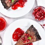 Original food photography of two slices of pie with pomegranate sauce