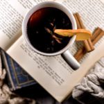 Mulled wine in a mug, on top of a stack of books