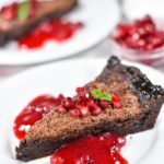 A slice of shoo fly pie with pomegranate sauce