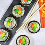 Sushi macarons, chopsticks, and slate board