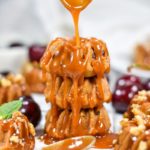 A stack of mini bundt cakes and a spoon drizzling caramel