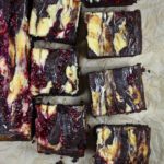 Cheesecake brownies on parchment