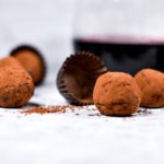 Red wine truffles, cocoa powder, and glass of wine