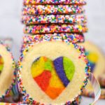 Heart cookie and stack of cookies with rainbow sprinkles
