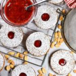 Linzer cookies and jam on a metal rack
