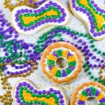 Mardi gras cookies surrounded by beads