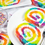 Rainbow cake roll on a white plate