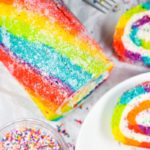 Looking down at a rainbow cake roll and slices
