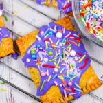 Hand pie with purple frosting and sprinkles