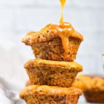 Three muffins being drizzled with caramel