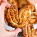 Hand holding a French palmier cookie