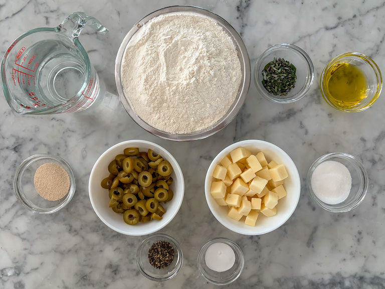 ingredients for making a rustic cheese and olive bread