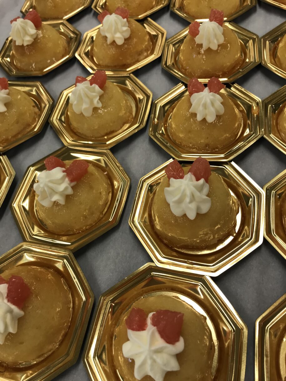 Citrus savarin afternoon tea desserts on gold presentation plates