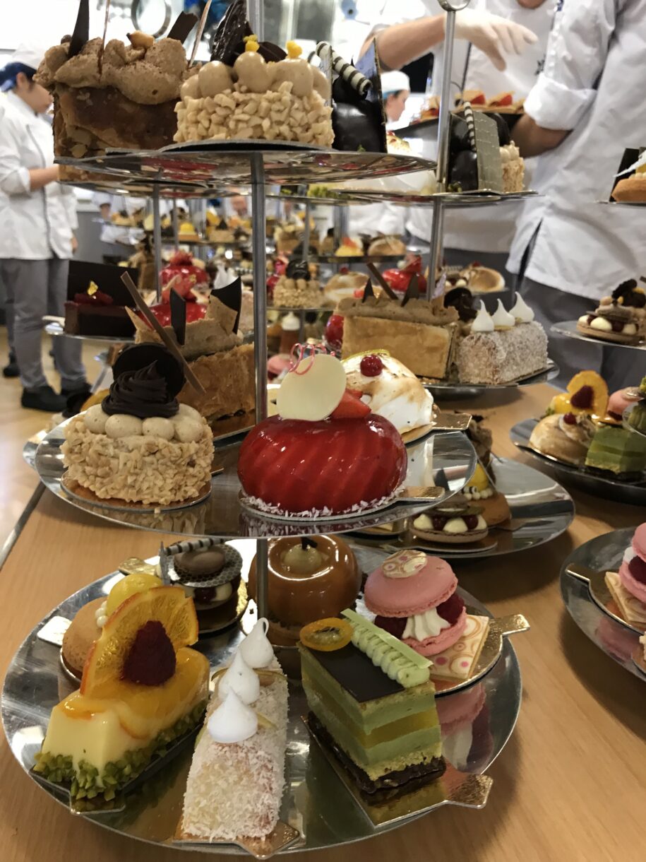 Afternoon tea desserts arranged on silver tiered trays