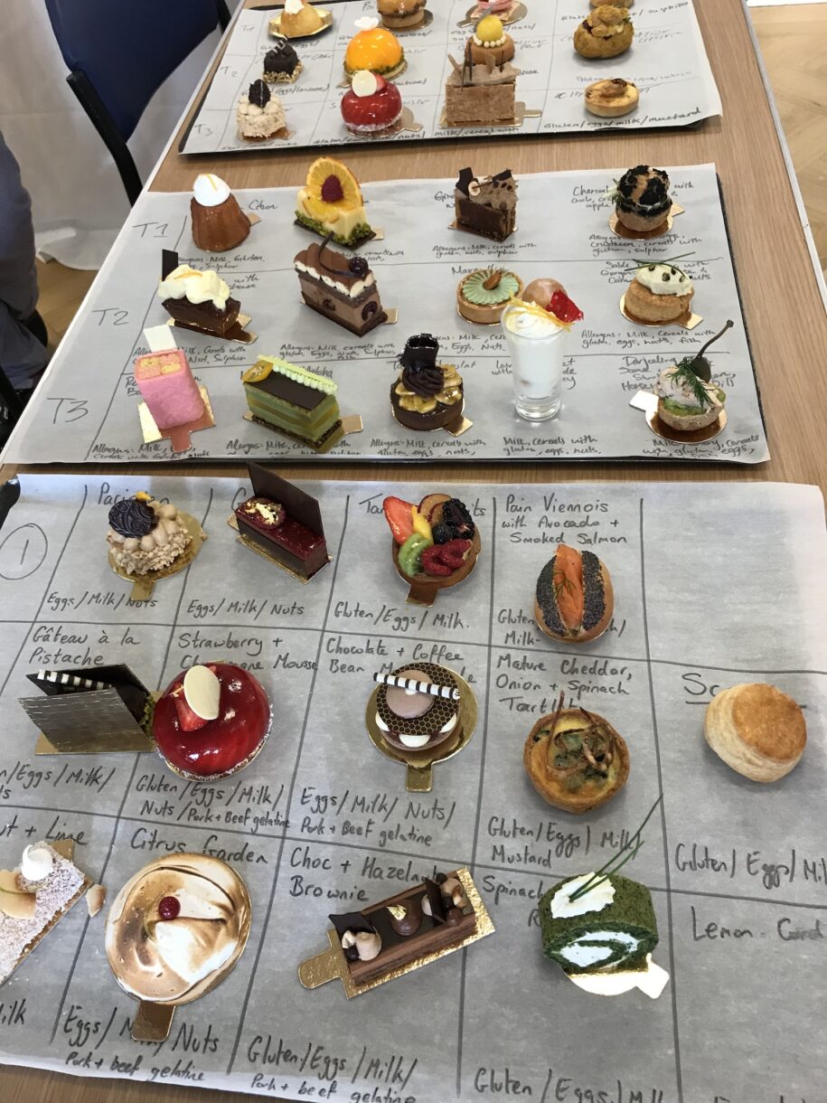 Individually sized desserts on sheets of parchment, arranged on a table