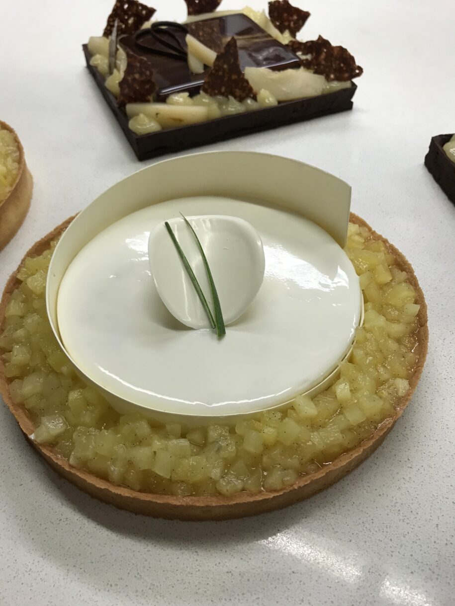 A modern white chocolate and pineapple tart with a white chocolate hoop