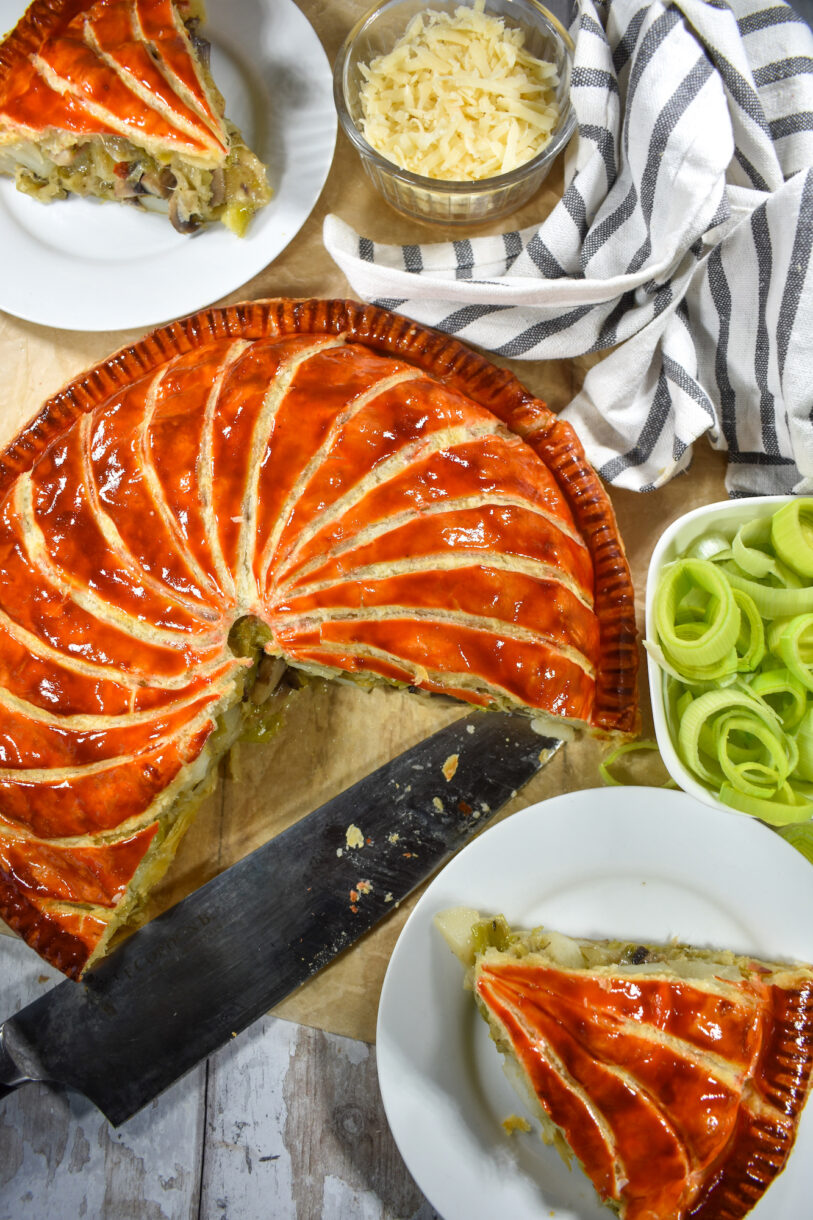 Pithiver with slices, leeks, cheese, and a knife