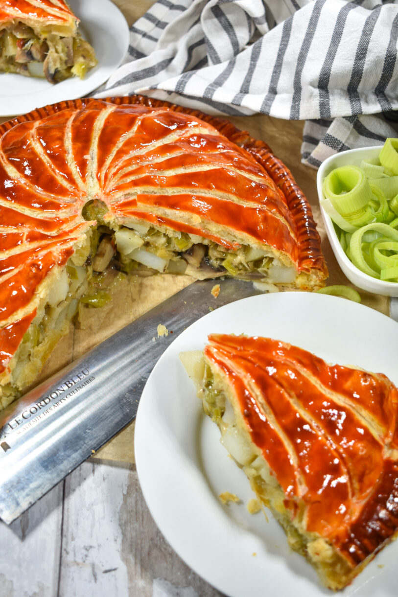 Sliced pithivier and plated slices with a knife and tea towel