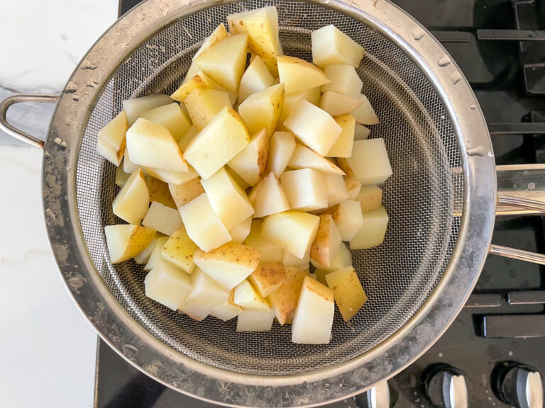 Diced potatoes in a colander