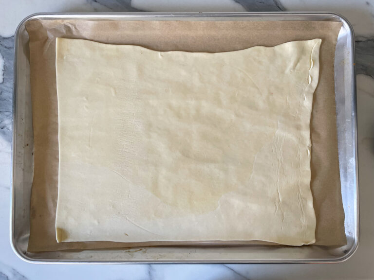 Sheet of puff pastry on a metal tray