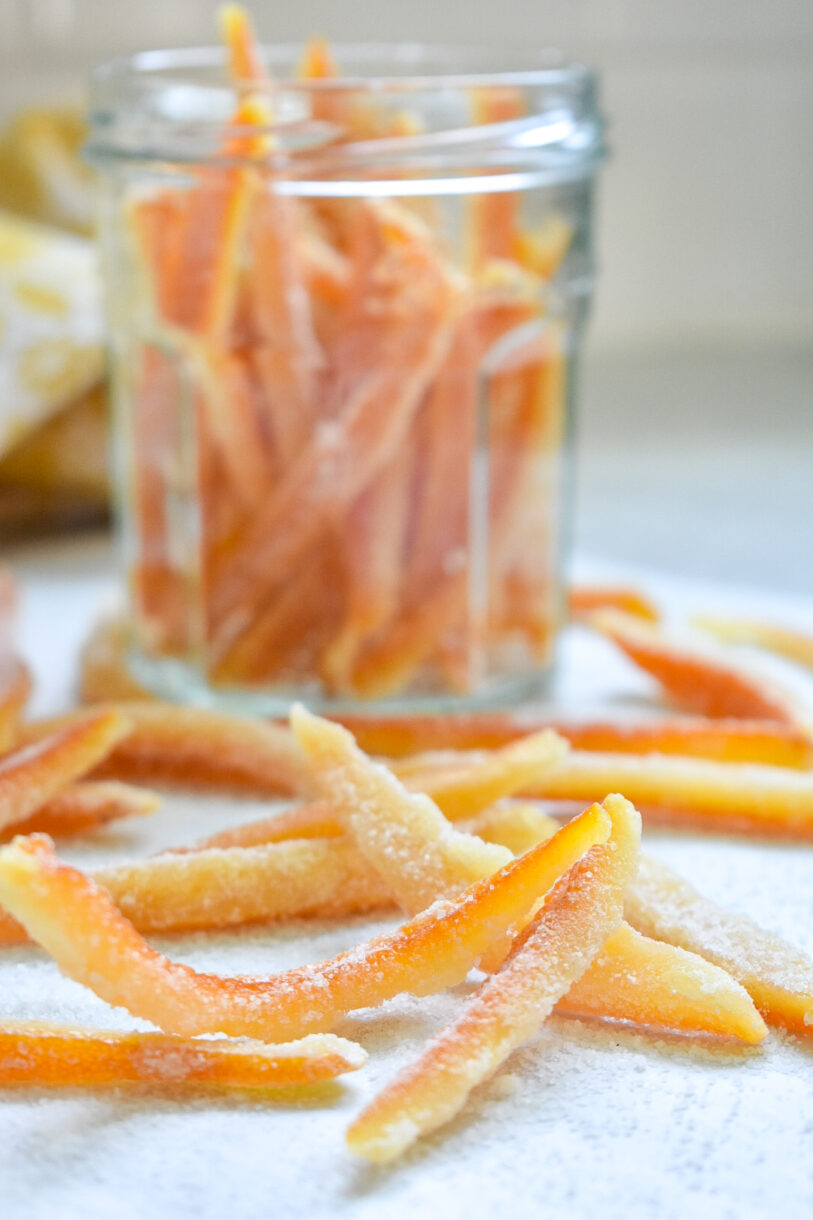 Candied orange peels in a glass jar, made from an original candied orange peel recipe