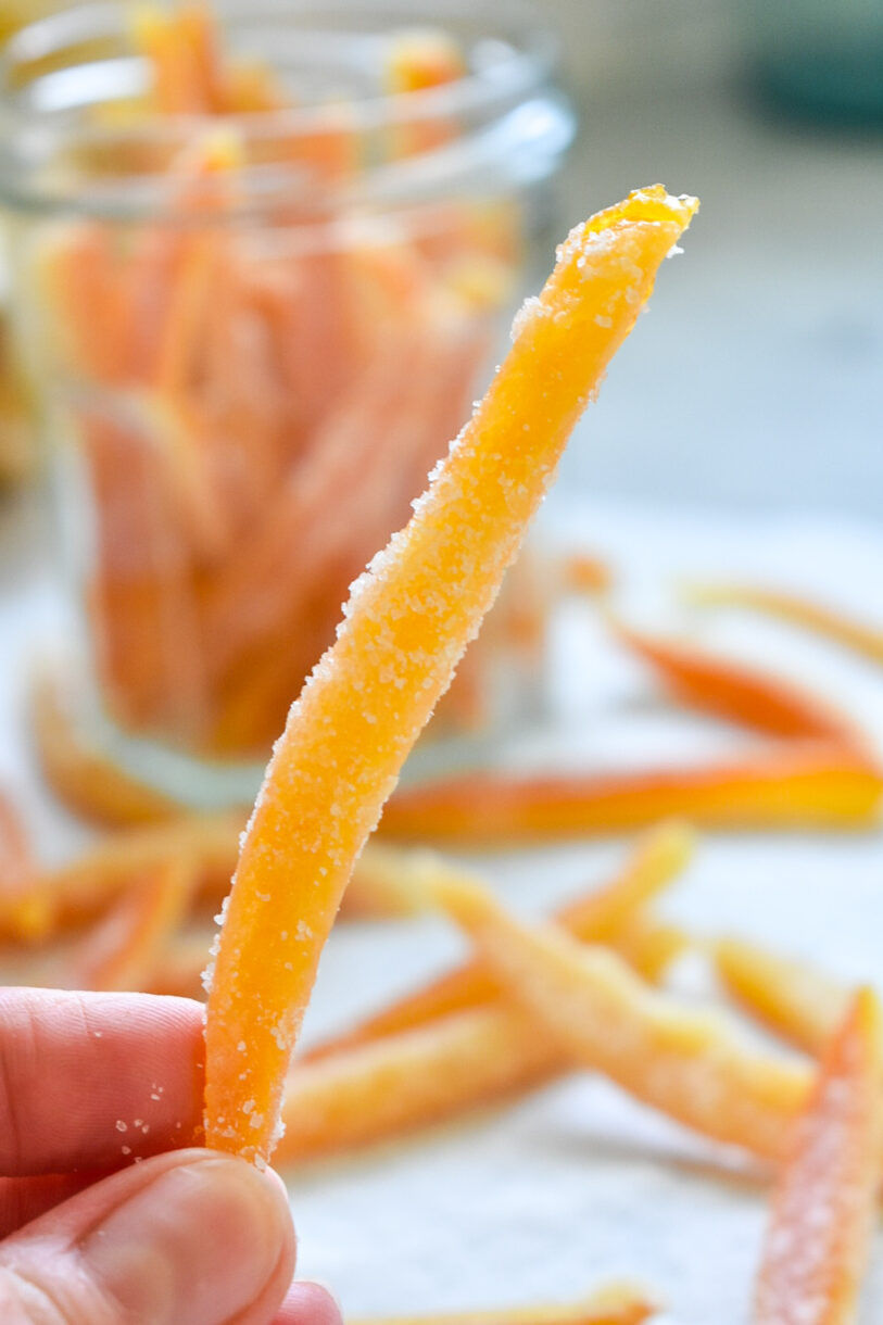 Hand holding a candied orange peel