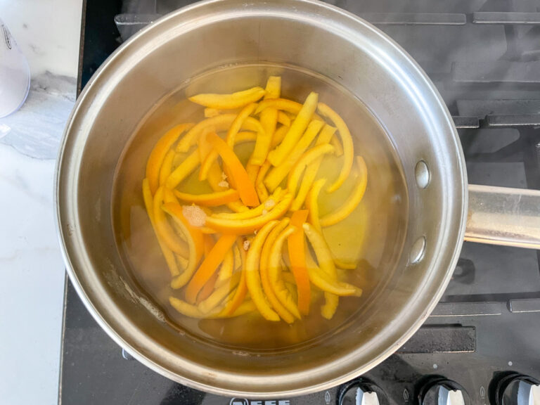 Orange peels in a metal saucepan on stovetop