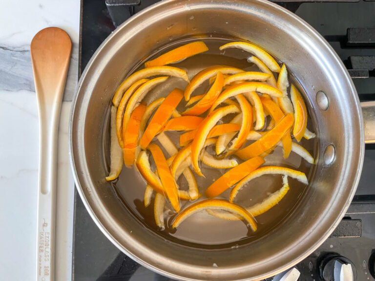 Orange peels in a metal saucepan on stovetop