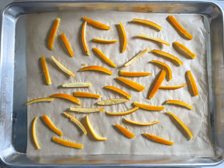 Candied orange peels on parchment lined tray