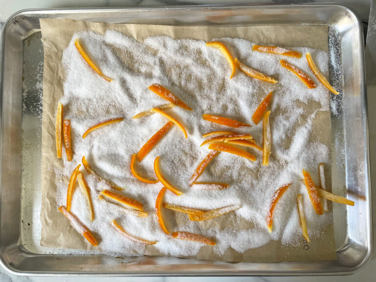 Candied orange peels on parchment lined tray