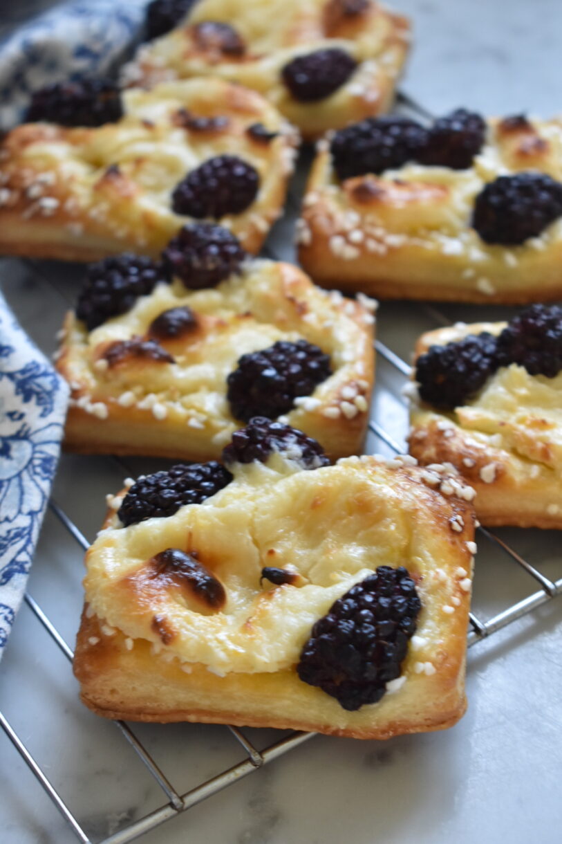 Blackberry cream cheese pastries on a wire cooling rack