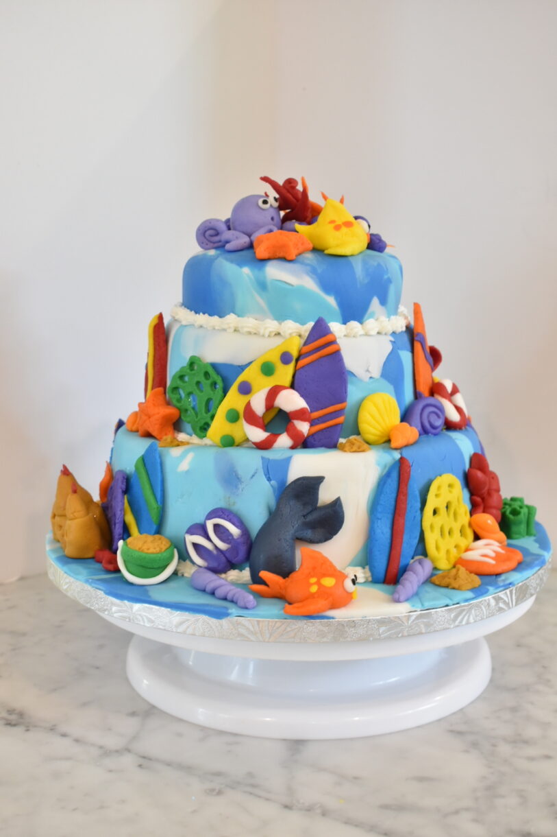 Beach themed cake decorated with rolled and modelled fondant