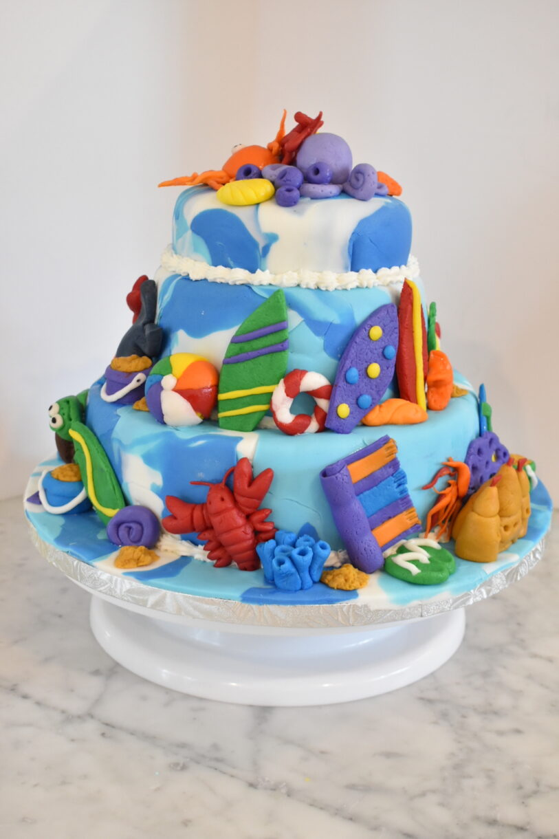 Tiered beach themed fondant cake