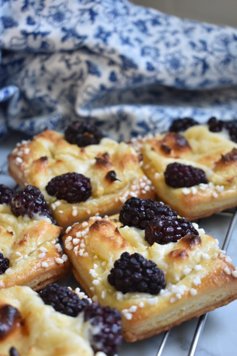 Blackberry cream cheese pastries and a blue floral print towel