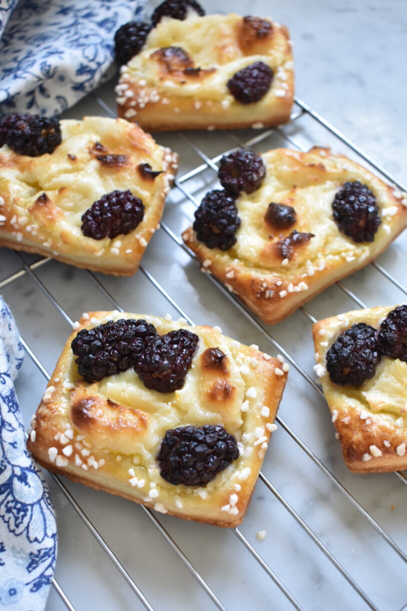 Blackberry cream cheese pastries on a wire rack